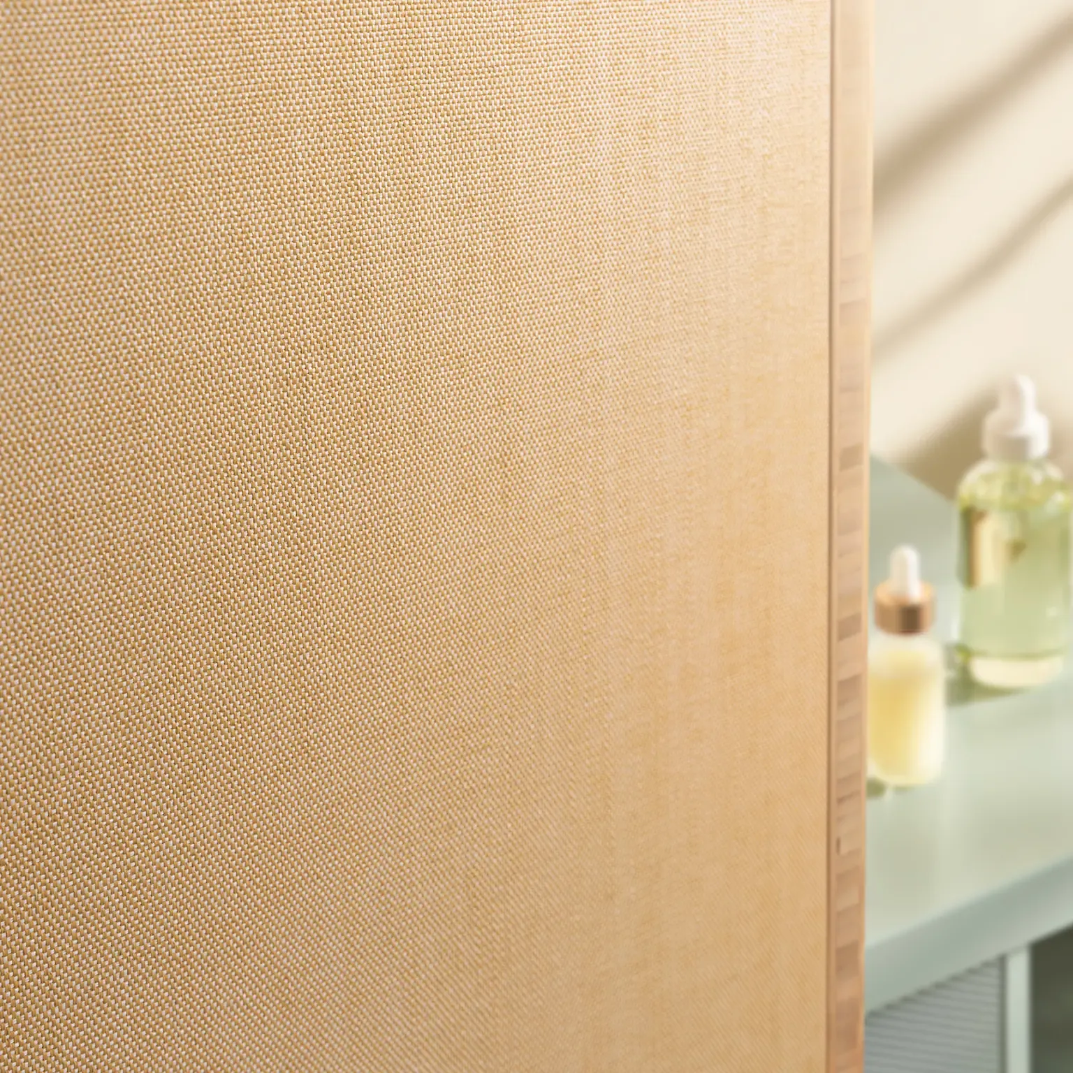 Textured light beige fabric wall panel with soft lighting